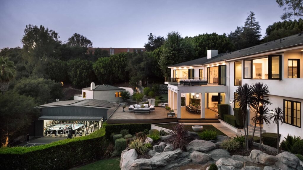 Mark Wahlberg’s former Beverly Hills estate is on the market for \$21.8M featuring seven bedrooms, luxury amenities, a grotto pool, guesthouse, gym and canyon views.